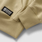 Smuggler Fleece Crew in tan fleece, shown in close up with ribbed hem and cuff details plus a black Zero Foxtrot logo patch