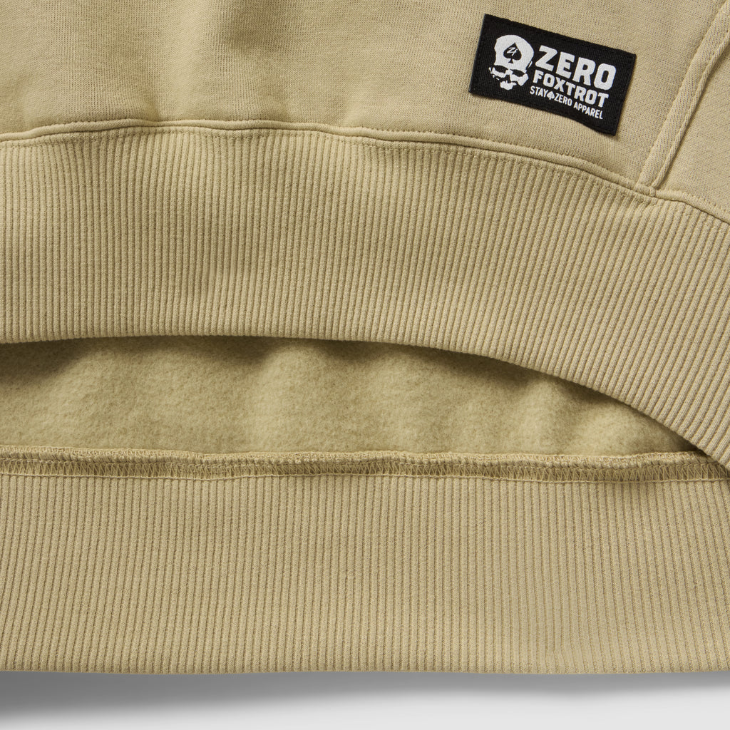 Smuggler Fleece Crew in beige fleece with ribbed hem detailing and a Zero Foxtrot label closeup