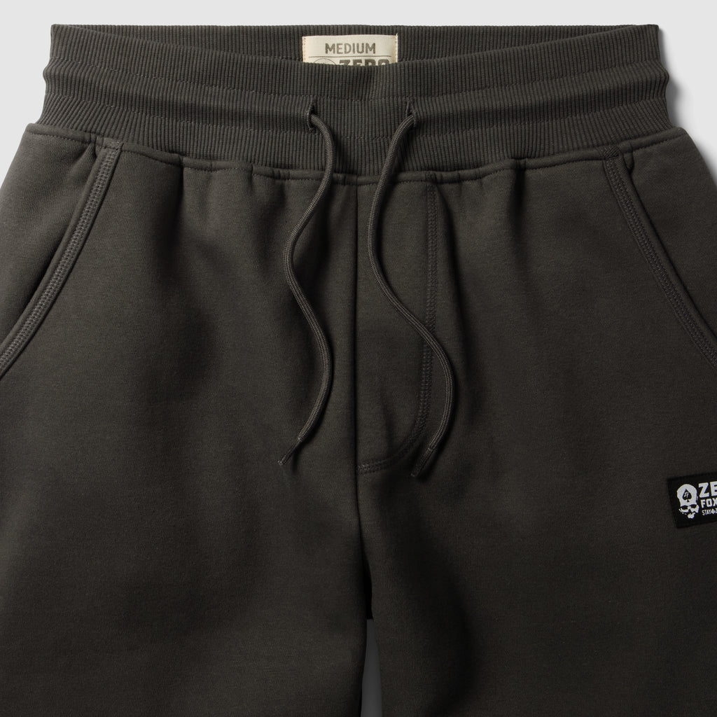 Smuggler Fleece Jogger in dark charcoal fleece with an elastic drawstring waistband slanted front pockets and a small logo patch