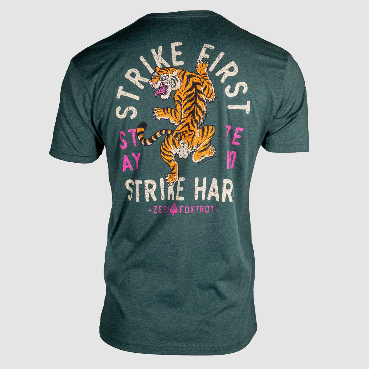 Back view of a dark green Strike Hard Tee featuring a colorful tiger graphic with text that reads "Strike First, Stay Hard, Strike Hard" in bold letters.
