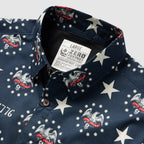 Close-up of a dark blue Surf Shirts with white stars and eagle motifs featuring "Zero Foxtrot" text, showcasing a button-up collar and patriotic design elements.