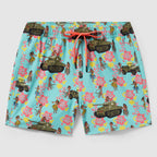 Swim Trunks featuring a light blue background with a playful pattern of vintage military tanks, jeeps, and hula dancers surrounded by pink and yellow tropical flowers and a coral drawstring waistband.