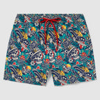 Swim Trunks with a colorful tattoo-style skull pattern featuring hats, roses, hearts, and banners on a teal background with a red drawstring waistband.