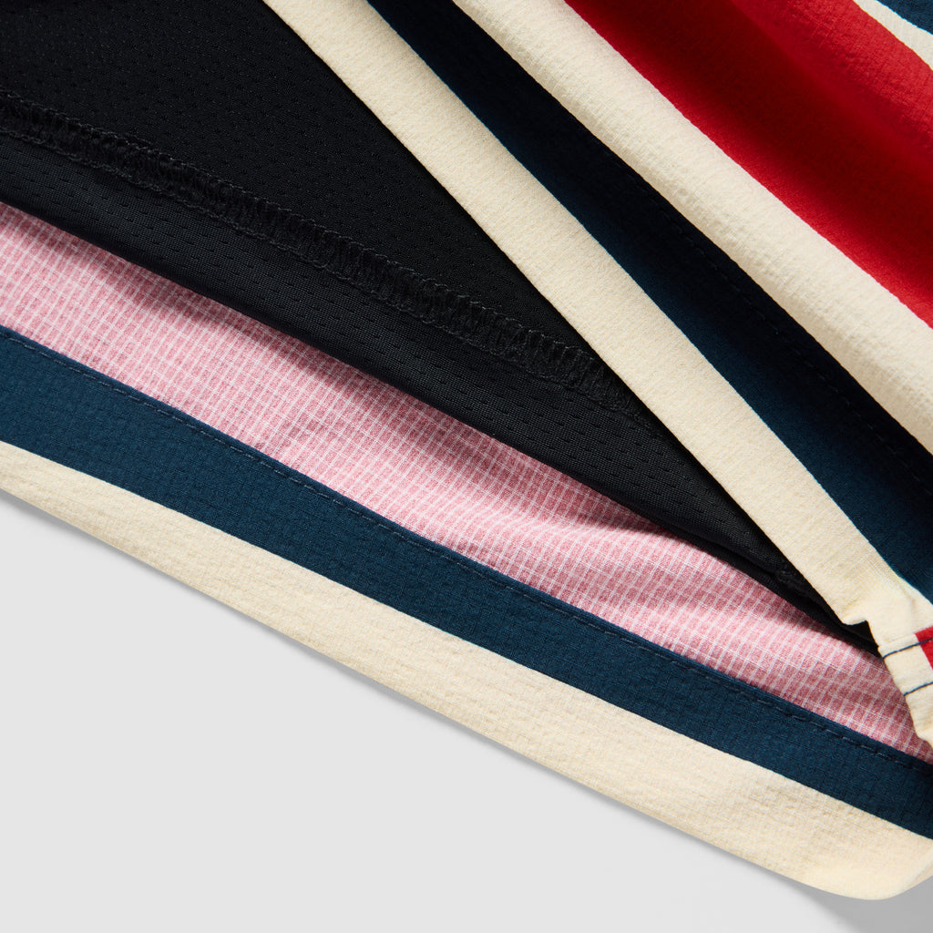 Close-up of the fabric and stitching details on the Old Glory Swim Trunks, featuring layered red, white, blue, and black colors with contrasting textured patterns.