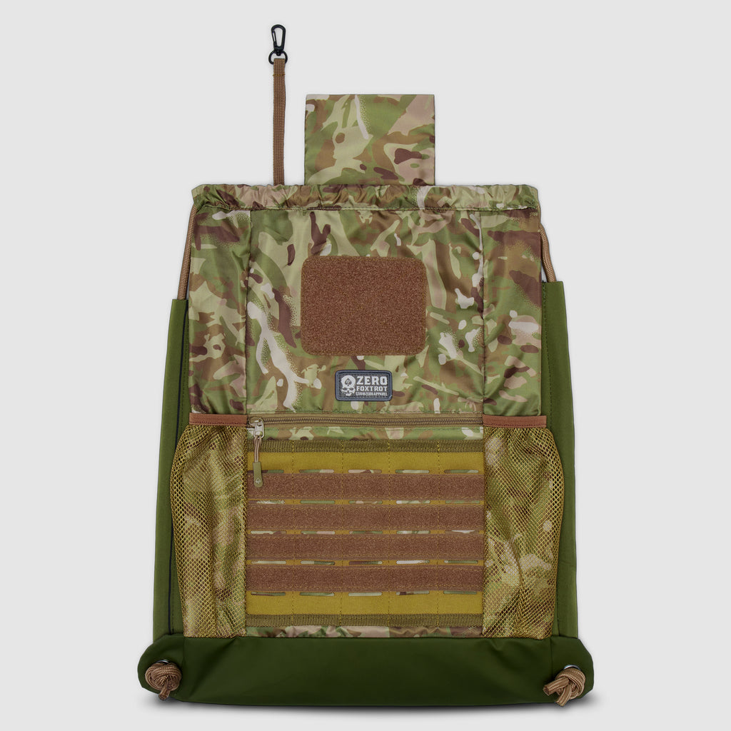 Open camouflage TAC Drawstring Pack showing interior compartments with mesh pockets, MOLLE webbing, and a key clip strap detail.