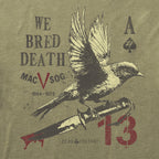 Detail view of olive green We Bred Death Tee featuring a black and white bird perched on a large dagger with blood dripping, and vintage military-style text and symbols.