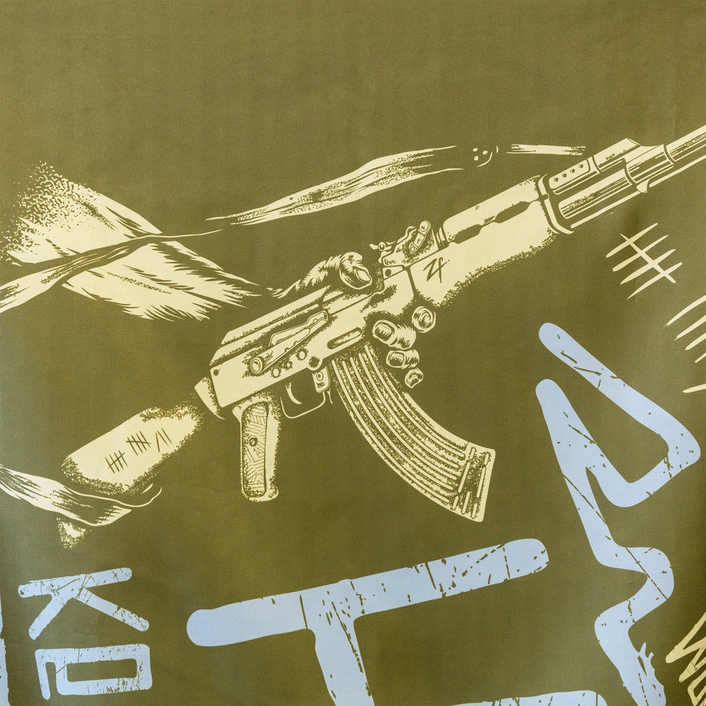 Hate Keeps Me Warm Flag in olive green with a distressed rifle illustration, tally marks, and large blue painted lettering for a rebellious graphic look