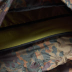 Interior view of a Woobie Backpack showing durable camouflage-patterned fabric and a padded compartment for secure storage.