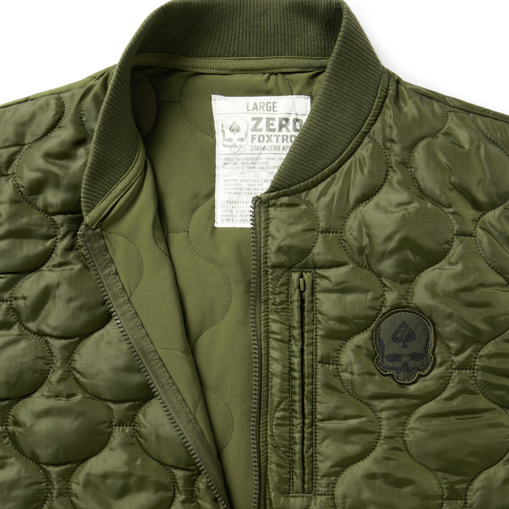 Woobie Vest (Last Chance), olive quilted vest close up with ribbed collar, front zipper, chest pocket, and embroidered chest patch