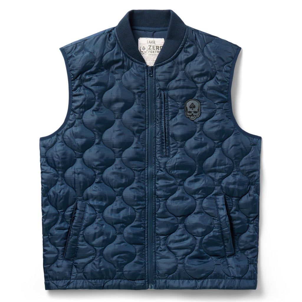 Woobie Vest (Last Chance), navy quilted outerwear vest with zip front, stand collar, side pockets, and skull patch on the chest against a white background