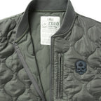 Woobie Vest (Last Chance), close up of an olive quilted vest with ribbed collar, front zipper, chest pocket, skull patch, and large size label