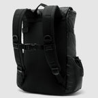 Woobie Backpack in black, shown from the back with padded shoulder straps, adjustable chest strap, and a handle on top, made from durable fabric with side pockets.