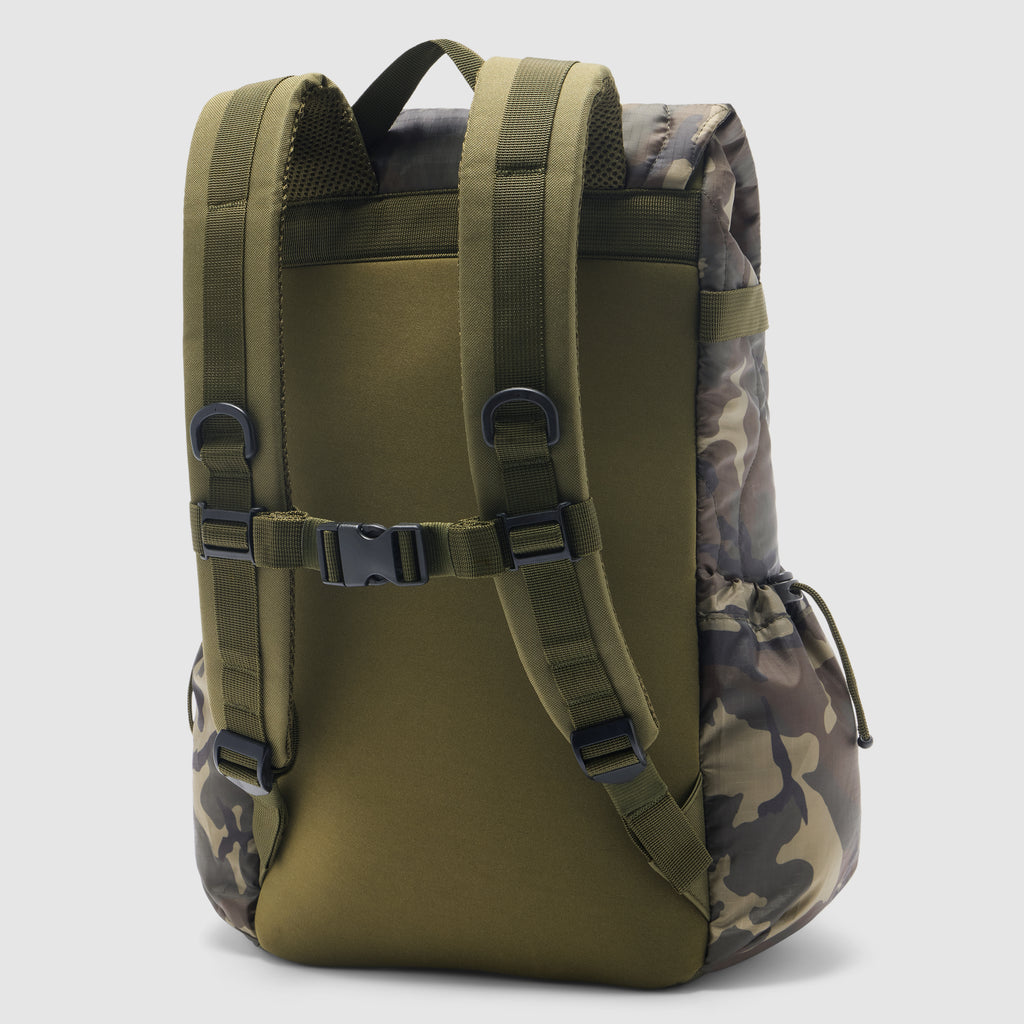Woobie Backpack in olive green with camouflage side panels, padded shoulder straps, adjustable chest buckle, and side pockets shown from the back