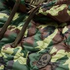 Woobie Hoodie (Last Chance) close up showing quilted green camouflage fabric, drawstrings, hood edge, and a stitched skull patch on the front panel