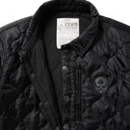 Woobie Shacket in black with quilted fabric, snap front, collared neckline, zippered chest pocket, and skull patch on the front.