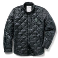 Woobie Shacket in black with quilted fabric, button front, collar, long sleeves, and a small skull patch on the chest against a white background