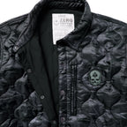 Woobie Shacket featuring black quilted camouflage fabric a snap front collar zippered chest pocket and skull patch detail close up view