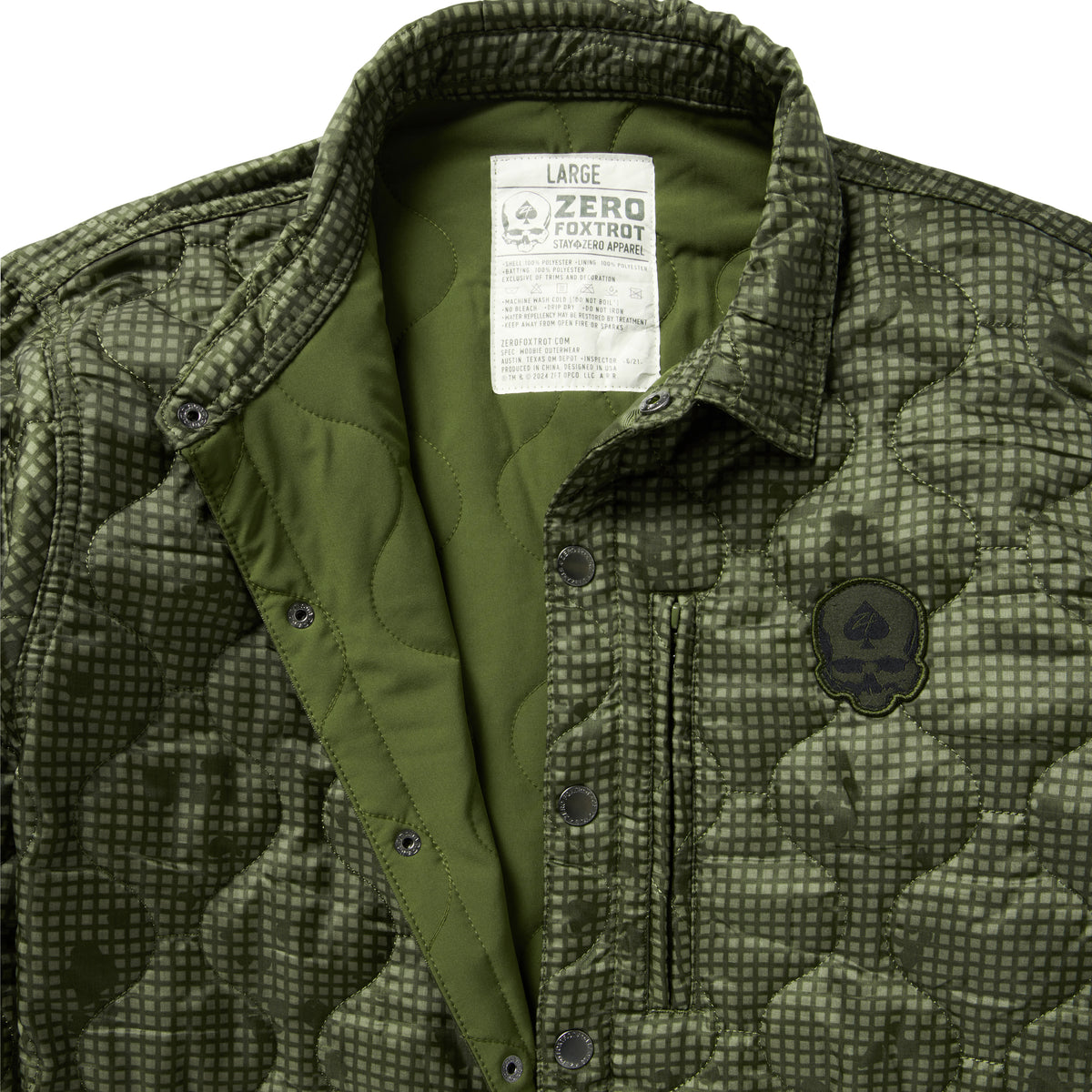 Woobie Shacket in olive green camouflage with quilted lining, corduroy collar, snap button front, chest pocket, and embroidered patch detail