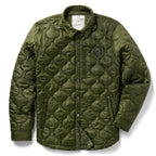 Woobie Shacket in olive green with quilted texture, button front, shirt collar, long sleeves, chest emblem, and front pockets on a white background