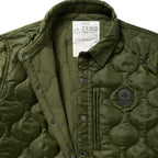 Woobie Shacket in olive green with quilted texture snap button front collar chest patch and interior label shown in close up