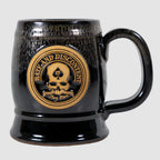 Zero Dark Mug in black ceramic with a skull and spade emblem and the phrase "Laugh and Disconvene" embossed in brown on the front.