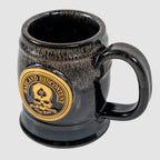 Zero Dark Mug with a glossy black and dark brown gradient finish featuring a gold emblem of a skull and the words "Ruthless and Discontent" on the front.