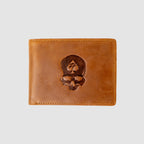 Smuggler Leather Wallet in brown leather featuring a dark embossed skull design with a spade symbol, showcasing fine stitching and a smooth finish.