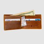 Smuggler Leather Wallet open to show brown leather interior with multiple card slots, a U.S. twenty-dollar bill, and several cards including a Texas driver’s license and a VA identification card.