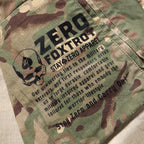 Close-up of camouflage fabric with black printed text and a skull graphic, displaying a motivational military-inspired message on the Chore Jacket.
