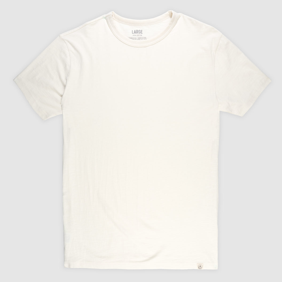 Plain off-white short sleeve cotton t-shirt laid flat, featuring a crew neck and soft texture, shown as the Cotton Skivvy Tee.