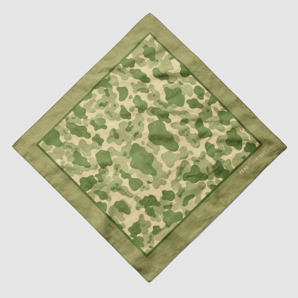 Green and beige camouflage patterned bandana with a solid green border, featuring subtle text detail, part of the ZF Bandanas collection.