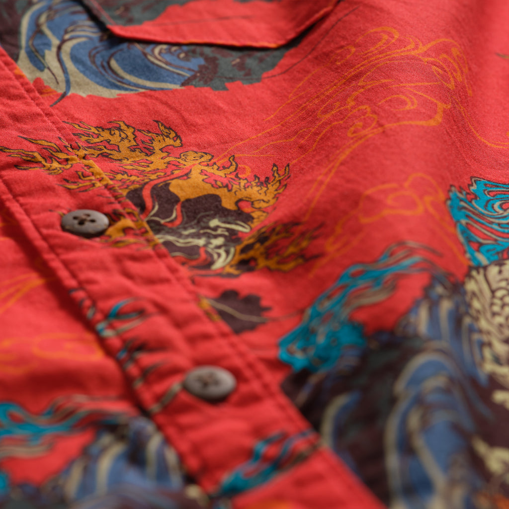 Surf Shirts (Last Chance) featuring a red button front with vivid multicolor dragon and wave inspired patterns close up