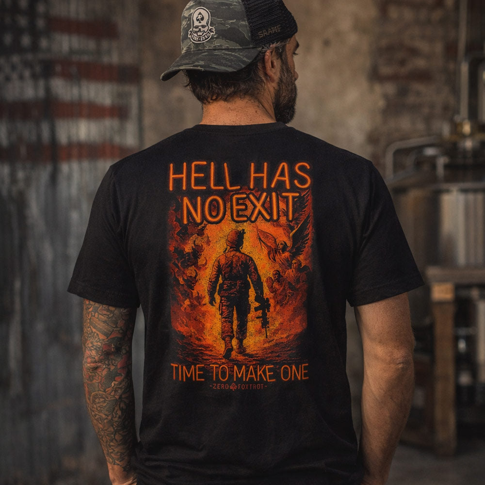 Man wearing a black No Exit Tee with a vivid fiery graphic on the back showing a soldier walking into flames with the text "Hell Has No Exit" and "Time to Make One" in bold orange letters.