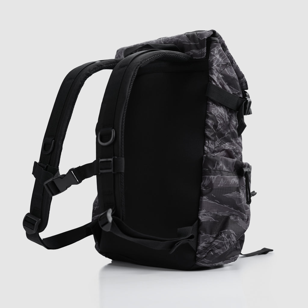 Side view of a Woobie Backpack in black with gray tiger stripe pattern, featuring padded shoulder straps and adjustable buckles for comfortable carrying.