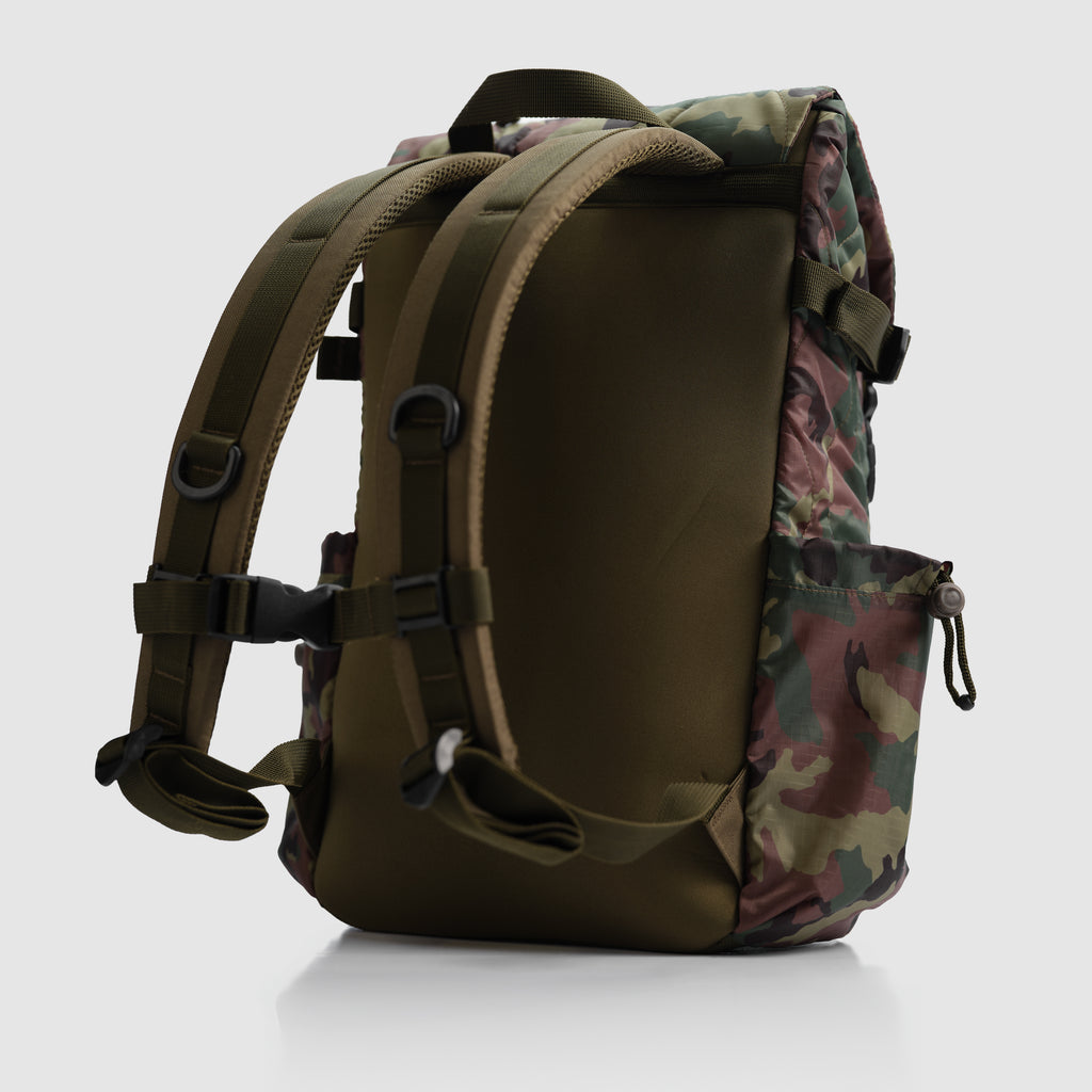 Woobie Backpack shown from the back, featuring padded shoulder straps and camouflage pattern with woodlands colors, designed for outdoor and tactical use.