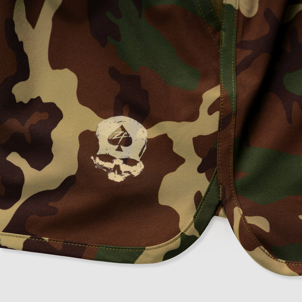 Close-up of camouflage patterned fabric featuring a white skull and spade graphic, part of the Zero Shorts - 9" Inseam.