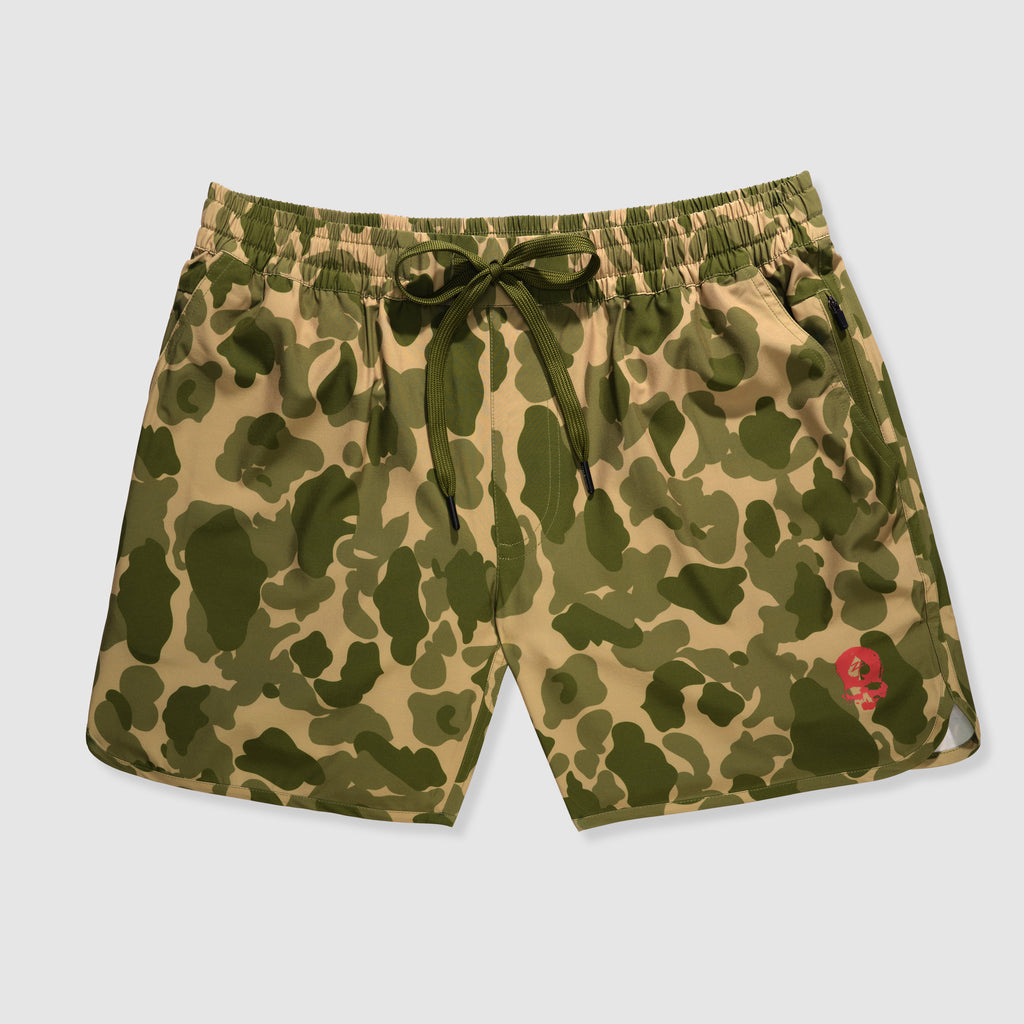 Camouflage patterned shorts with an elastic waistband and drawstring, featuring a red skull logo on the leg, designed as Zero Shorts - 7" Inseam.