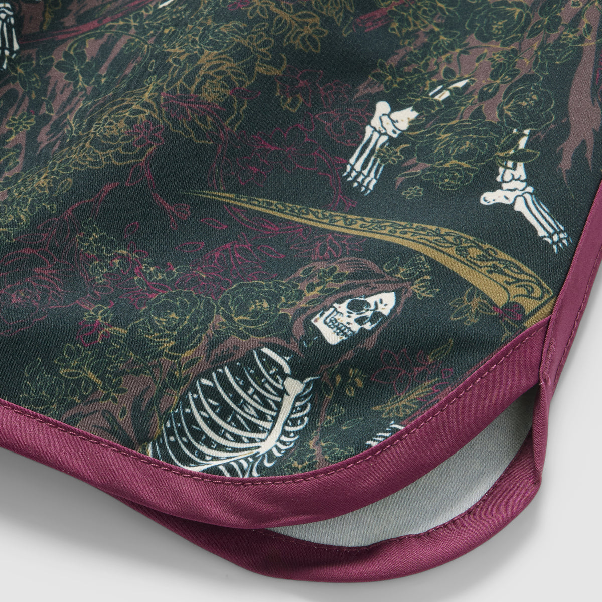 Close-up of black and dark green ZF Fight Shorts with purple edging, featuring a detailed skeleton and floral pattern with gold and red accents.