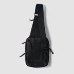 Surplus EDC Sling black crossbody bag with adjustable shoulder strap front zip pocket and compact rectangular design against a light background