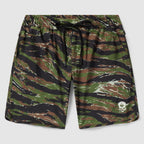 Zero Shorts - 9" Inseam featuring a green, brown, and black camouflage pattern with an elastic waistband, black drawstring, and a small white skull logo on the hem.
